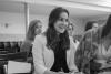 Elizabeth Lasmane - A white girl in a white jacket in a lecture room with other people.